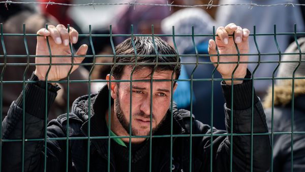 A migrant waits at a Turkish coast guard station at the Dikili district in Izmir, on March 20, 2016 after being catched with other migrants while trying to reach the Greek island of Lesbos from the Bademli village, western Turkey. - Sputnik International