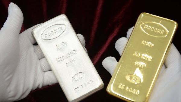 A worker holds a gold bar and a silver bar produced during the opening of a new bank bar manufacturing line at a plant in Yekaterinburg. - Sputnik International