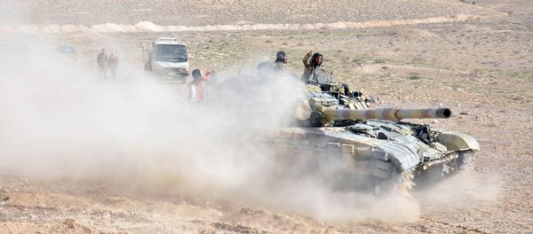 Forces loyal to Syria's President Bashar al-Assad drive a tank during their offensive to recapture the historic city of Palmyra in this picture provided by SANA on March 24, 2016. Forces loyal to Syria's President Bashar al-Assad drive a tank during their offensive to recapture the historic city of Palmyra in this picture provided by SANA on March 24, 2016. - Sputnik International