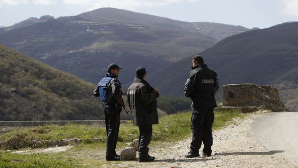 Police officers look towards the Macedonian mountain village of Gosince from a police check point set near the northern Macedonian border with Kosovo. (File) Police officers look towards the Macedonian mountain village of Gosince from a police check point set near the northern Macedonian border with Kosovo. (File) - Sputnik International