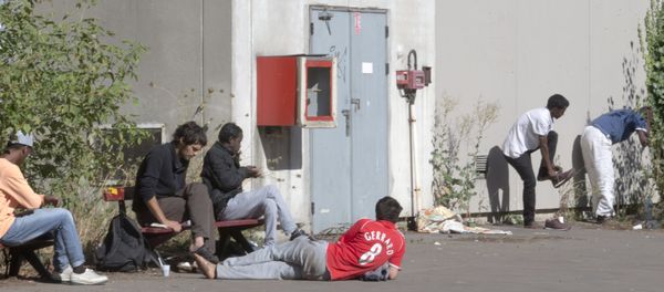 Migrants rest in the grounds of the Guillaume-Bude secondary school building in Paris. (File) Migrants rest in the grounds of the Guillaume-Bude secondary school building in Paris. (File) - Sputnik International