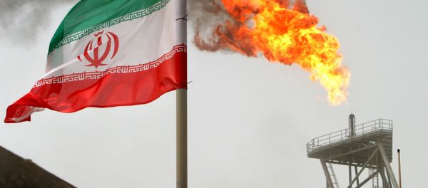 A gas flare on an oil production platform in the Soroush oil fields is seen alongside an Iranian flag in the Persian Gulf, in this July 25, 2005 file photo A gas flare on an oil production platform in the Soroush oil fields is seen alongside an Iranian flag in the Persian Gulf, in this July 25, 2005 file photo - Sputnik International