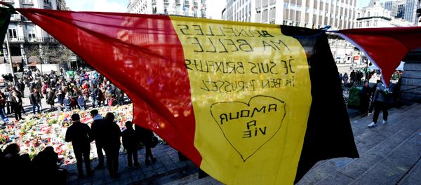 A Belgian flag reading Brussels my beauty, I am Brussels flutters as people gather at the makeshift memorial outside the stock exchange in Brussels on March 27, 2016 an area which has become an unofficial shrine to victims of the March 22, terror attacks. A Belgian flag reading Brussels my beauty, I am Brussels flutters as people gather at the makeshift memorial outside the stock exchange in Brussels on March 27, 2016 an area which has become an unofficial shrine to victims of the March 22, terror attacks. - Sputnik International