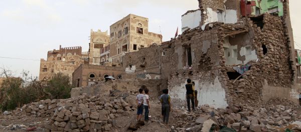 Yemeni children look on March 23, 2016 at buildings that were damaged by air strikes carried out by the Saudi-led coalition over the past year in the UNESCO-listed old city of the Yemeni capital Sanaa Yemeni children look on March 23, 2016 at buildings that were damaged by air strikes carried out by the Saudi-led coalition over the past year in the UNESCO-listed old city of the Yemeni capital Sanaa - Sputnik International