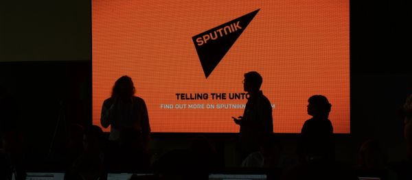 A screen with the logo of the Sputnik international news agency - Sputnik International