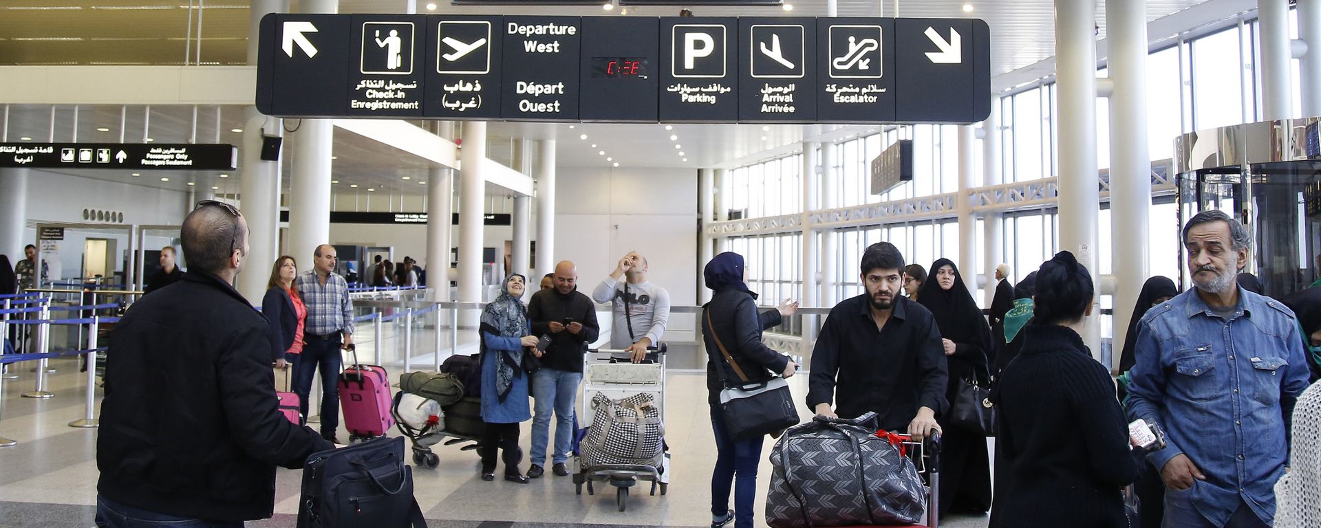 Travelers check the flight schedule screens for delays or cancellations, at the departure terminal of Rafik Hariri international airport in the Lebanese capital, Beirut, on November 21, 2015 Travelers check the flight schedule screens for delays or cancellations, at the departure terminal of Rafik Hariri international airport in the Lebanese capital, Beirut, on November 21, 2015 - Sputnik International, 1920, 19.09.2024