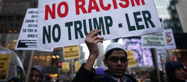 A Muslim youth holds a poster during a protest against Donald Trump on December 20, 2015 in New York - Sputnik International