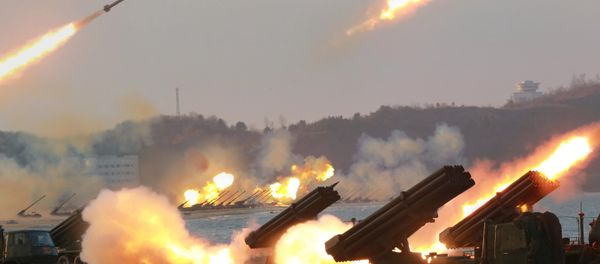 Multiple rocket launchers are seen being fired during a military drill at an unknown location, in this undated photo released by North Korea's Korean Central News Agency (KCNA) on March 25, 2016 - Sputnik International