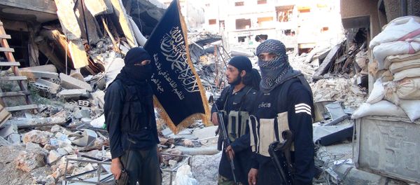 Fighters from the al-Qaida group in the Levant, Al-Nusra Front, stand among destroyed buildings near the front line with Syrian government solders in Yarmuk Palestinian refugee camp, south of Damascus on September 22, 2014 Fighters from the al-Qaida group in the Levant, Al-Nusra Front, stand among destroyed buildings near the front line with Syrian government solders in Yarmuk Palestinian refugee camp, south of Damascus on September 22, 2014 - Sputnik International