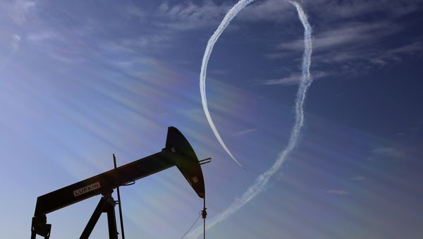 In this Saturday, Jan. 23, 2016, file photo, an oil pump stands as the Saudi Hawks Aerobatic Team of the Royal Saudi Air Force performs during the Bahrain International Airshow in Sakhir, Bahrain - Sputnik International