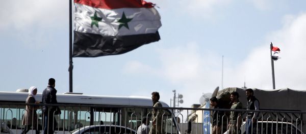 People walk near a Syrian national flag at the President bridge in Damascus, Syria March 14, 2016 People walk near a Syrian national flag at the President bridge in Damascus, Syria March 14, 2016 - Sputnik International