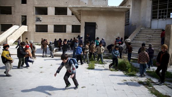 School children clean the courtyard of their school in the rebel held Douma neighborhood of Damascus, Syria, March 29, 2016 - Sputnik International