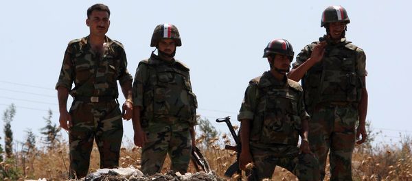 Syrian soldiers stand guard near a mass grave (File) - Sputnik International