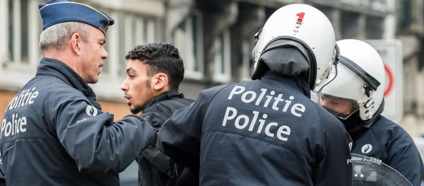 Policemen detain a man in the Molenbeek neighborhood in Brussels, Belgium Policemen detain a man in the Molenbeek neighborhood in Brussels, Belgium - Sputnik International