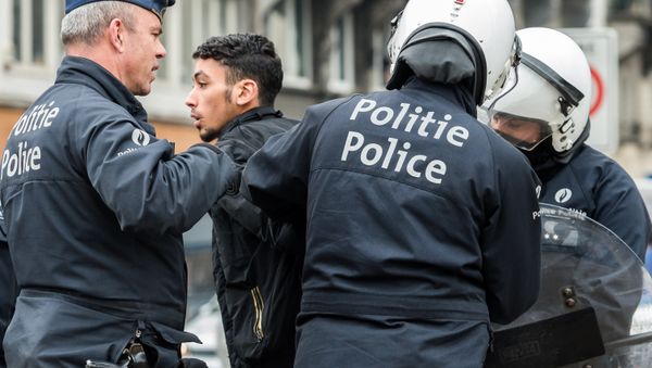 Policemen detain a man in the Molenbeek neighborhood in Brussels, Belgium Policemen detain a man in the Molenbeek neighborhood in Brussels, Belgium - Sputnik International