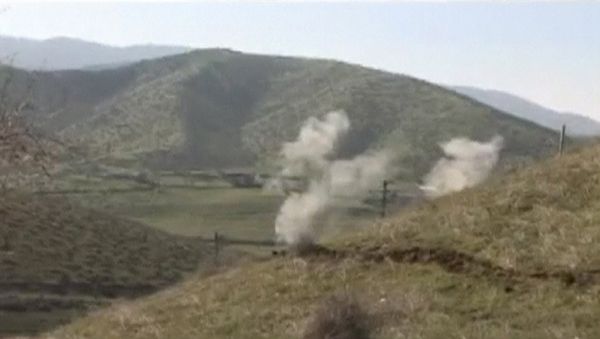 Smoke rises after clashes between Armenian and Azeri forces in Nagorno-Karabakh region in this still image taken from video provided by the Nagorno-Karabakh region Defence Ministry April 2, 2016. - Sputnik International