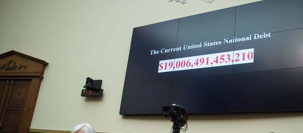A screen shows the US national debt before US Federal Reserve chair Janet Yellen (front L) testifies before the House Financial Services Committee on Capitol Hill in Washington, DC, on February 10, 2016. A screen shows the US national debt before US Federal Reserve chair Janet Yellen (front L) testifies before the House Financial Services Committee on Capitol Hill in Washington, DC, on February 10, 2016. - Sputnik International