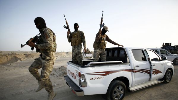 Iraqi Sunni men presented as former jihadists fighting alongside the Islamic State (IS) group who defected to join Iraq government forces take position in Amriyat al-Fallujah, in Iraq's Anbar province, on May 26, 2015. Iraqi Sunni men presented as former jihadists fighting alongside the Islamic State (IS) group who defected to join Iraq government forces take position in Amriyat al-Fallujah, in Iraq's Anbar province, on May 26, 2015. - Sputnik International