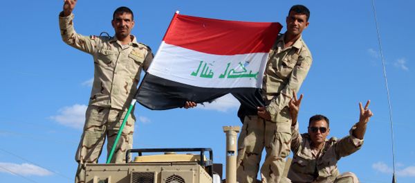 Iraqi government forces wave the national flag from their vehicles in the village of Mohammadi, a few miles north of Heet, in Iraq's western province of Anbar on March 18, 2016. Iraqi government forces wave the national flag from their vehicles in the village of Mohammadi, a few miles north of Heet, in Iraq's western province of Anbar on March 18, 2016. - Sputnik International