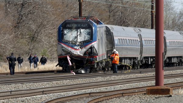 Emergency personnel examine the scene after an Amtrak passenger train struck a backhoe, killing two people, in Chester, Pennsylvania - Sputnik International