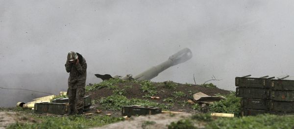 An Armenian serviceman of the self-defense army of Nagorno-Karabakh launch artillery toward Azeri forces in the town of Martakert in Nagorno-Karabakh region - Sputnik International