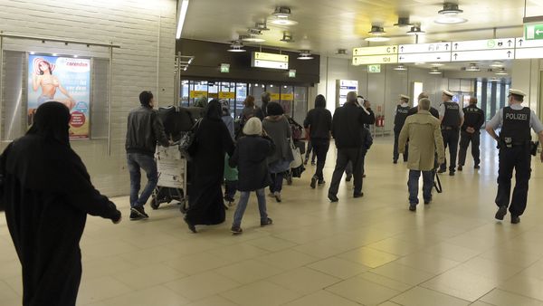 Policemen escort a group of refugees after their arrival at the airport in Hanover, central Germany, on April 4, 2016. - Sputnik International