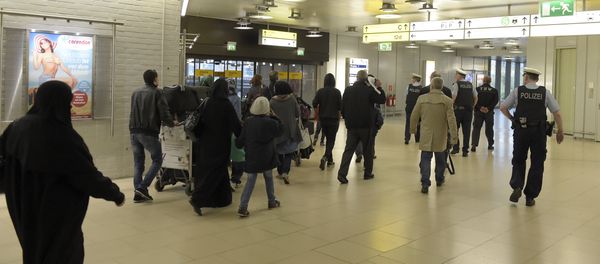 Policemen escort a group of refugees after their arrival at the airport in Hanover, central Germany, on April 4, 2016. Policemen escort a group of refugees after their arrival at the airport in Hanover, central Germany, on April 4, 2016. - Sputnik International