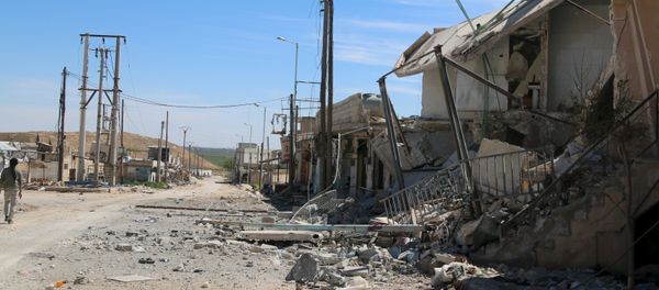 A man walks near damaged houses after Syrian rebels and the al Qaeda-affiliated Nusra Front took control of al-'Iss town, in Aleppo countryside, Syria April 2, 2016. A man walks near damaged houses after Syrian rebels and the al Qaeda-affiliated Nusra Front took control of al-'Iss town, in Aleppo countryside, Syria April 2, 2016. - Sputnik International