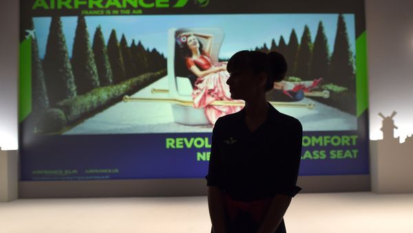 An Air France flight attendant looks at a screen at the new Air France Exhibition called Air France,france is in the Air - Sputnik International