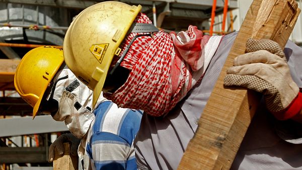 Foreign workers, covering their faces from dust and the blazing sun, work inside the Khouris central processiong oil facility that is still under construction in Saudi Arabia's desert, 160 kms east of the capital Riyadh (File) Foreign workers, covering their faces from dust and the blazing sun, work inside the Khouris central processiong oil facility that is still under construction in Saudi Arabia's desert, 160 kms east of the capital Riyadh (File) - Sputnik International