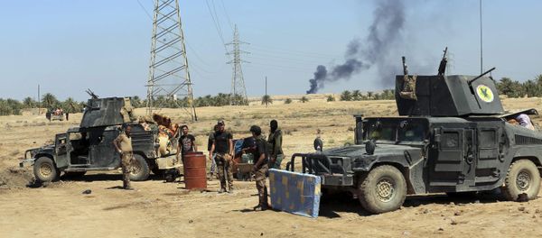 Smoke rises from Islamic State positions following a U.S.-led coalition airstrike as Iraqi Security forces surround the town of Hit, 85 miles (140 kilometers) west of Baghdad, Iraq, Saturday, April 2, 2016 - Sputnik International