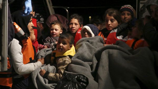 Refugee children are seen onboard a Greek Coast Guard vessel, carrying other refugees and migrants, as it arrives at the port of Mytilene on the Greek island of Lesbos, following a rescue operation at open sea, April 5, 2016 Refugee children are seen onboard a Greek Coast Guard vessel, carrying other refugees and migrants, as it arrives at the port of Mytilene on the Greek island of Lesbos, following a rescue operation at open sea, April 5, 2016 - Sputnik International