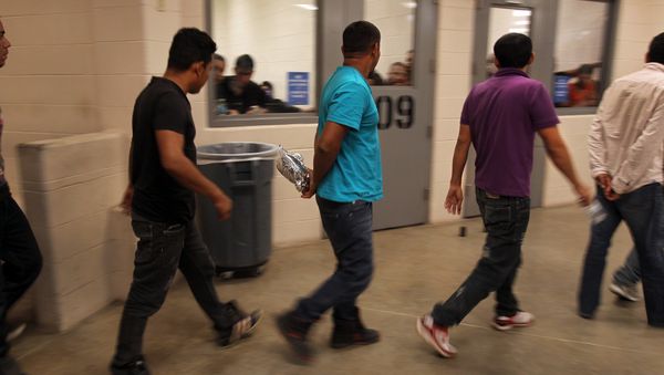 Immigrants who have been caught crossing the border illegally are housed inside the McAllen Border Patrol Station in McAllen, Texas, where they are processed on July 15, 2014 - Sputnik International