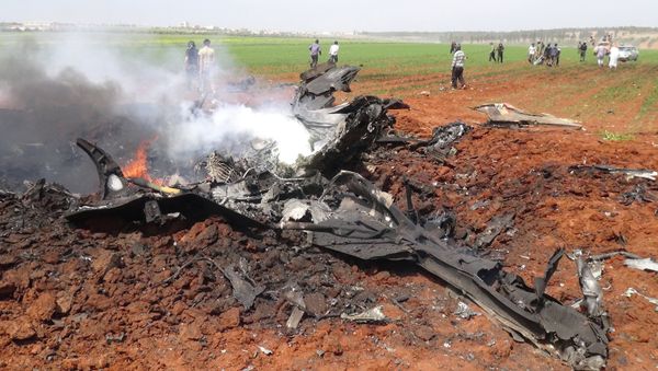 A general view shows the wreckage of a government warplane after Al-Nusra front (Al-Qaeda's Syria affiliate) reportedly shot it down over the northern Syrian town of Al-Eis on April 5, 2016 A general view shows the wreckage of a government warplane after Al-Nusra front (Al-Qaeda's Syria affiliate) reportedly shot it down over the northern Syrian town of Al-Eis on April 5, 2016 - Sputnik International