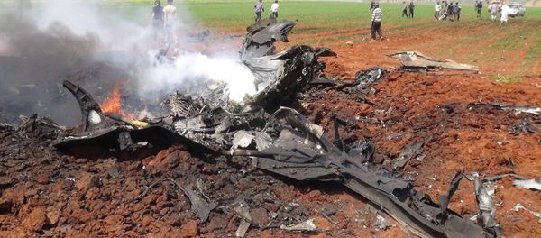 A general view shows the wreckage of a government warplane after Al-Nusra front (Al-Qaeda's Syria affiliate) reportedly shot it down over the northern Syrian town of Al-Eis on April 5, 2016 A general view shows the wreckage of a government warplane after Al-Nusra front (Al-Qaeda's Syria affiliate) reportedly shot it down over the northern Syrian town of Al-Eis on April 5, 2016 - Sputnik International