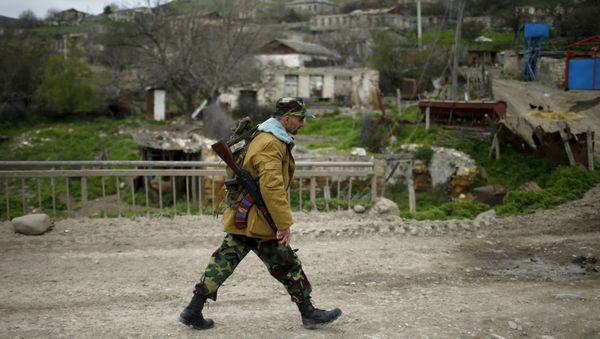 A volunteer walks on a road in the Nagorno-Karabakh's village of Talish April 6, 2016 - Sputnik International