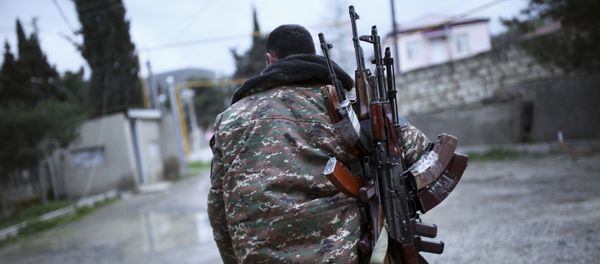 An ethnic Armenian fighter carries Kalashnikov machine guns to his comrade-in-arms at Martakert province in the separatist region of Nagorno-Karabakh, Azerbaijan, Monday, April 4, 2016 An ethnic Armenian fighter carries Kalashnikov machine guns to his comrade-in-arms at Martakert province in the separatist region of Nagorno-Karabakh, Azerbaijan, Monday, April 4, 2016 - Sputnik International