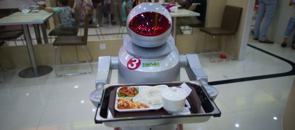 This photo taken on August 13, 2014, shows a robot carrying food to customers in a restaurant in Kunshan. It's more teatime than Terminator -- a restaurant in China is electrifying customers by using more than a dozen robots to cook and deliver food This photo taken on August 13, 2014, shows a robot carrying food to customers in a restaurant in Kunshan. It's more teatime than Terminator -- a restaurant in China is electrifying customers by using more than a dozen robots to cook and deliver food - Sputnik International