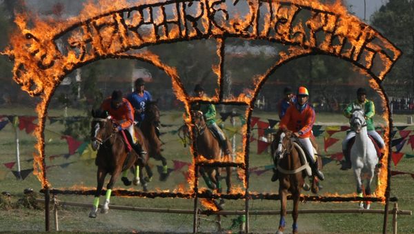 Nepalese soldiers on horseback jump through burning arches during the Ghode Jatra (horse race) festival in Kathmandu on April 3, 2011 Nepalese soldiers on horseback jump through burning arches during the Ghode Jatra (horse race) festival in Kathmandu on April 3, 2011 - Sputnik International