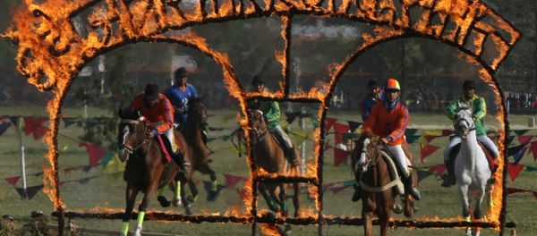 Nepalese soldiers on horseback jump through burning arches during the Ghode Jatra (horse race) festival in Kathmandu on April 3, 2011 Nepalese soldiers on horseback jump through burning arches during the Ghode Jatra (horse race) festival in Kathmandu on April 3, 2011 - Sputnik International