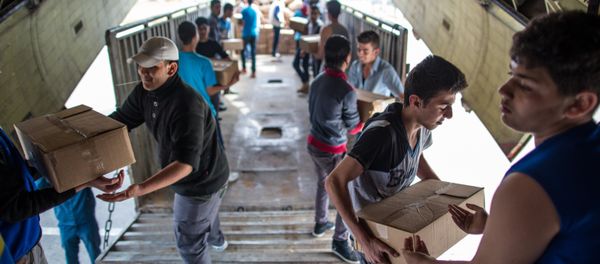 Unloading Russian EMERCOM plane with humanitarian aid which arrived to Latakia Airport in Syria. File photo Unloading Russian EMERCOM plane with humanitarian aid which arrived to Latakia Airport in Syria. File photo - Sputnik International