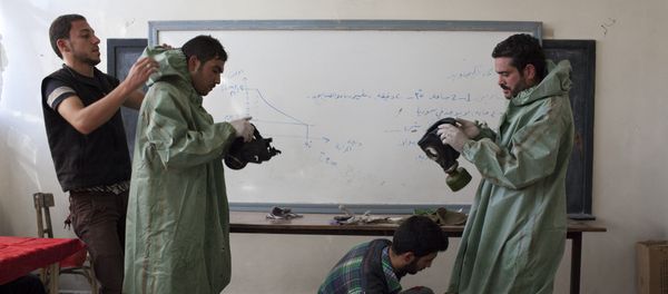 Aleppo University student, shows Syrian citizens hows to put protective gear as he instructs them with rudimentary means of how to respond to a chemical attack, in the northern Syrian city of Aleppo (File) Aleppo University student, shows Syrian citizens hows to put protective gear as he instructs them with rudimentary means of how to respond to a chemical attack, in the northern Syrian city of Aleppo (File) - Sputnik International