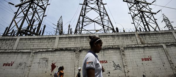 A woman walks in front of electricity pylons in Caracas, Venezuela (File) A woman walks in front of electricity pylons in Caracas, Venezuela (File) - Sputnik International