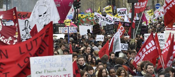 Demonstrators hold banners and signs during a protest on April 9, 2016 at the Place de la Bastille in Paris, against the French government's proposed labour law reforms - Sputnik International