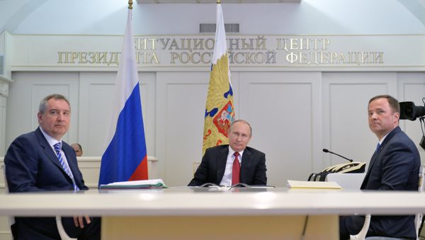 Russian President Vladimir Putin, center, Deputy Prime Minister Dmitry Rogozin, left, and Igor Komarov, General Director of the Roscosmos State Corporation for Space Activities, take part in a videoconference with the International Space Station and the Vostochny space center at the situation center in the Kremlin. Russian President Vladimir Putin, center, Deputy Prime Minister Dmitry Rogozin, left, and Igor Komarov, General Director of the Roscosmos State Corporation for Space Activities, take part in a videoconference with the International Space Station and the Vostochny space center at the situation center in the Kremlin. - Sputnik International