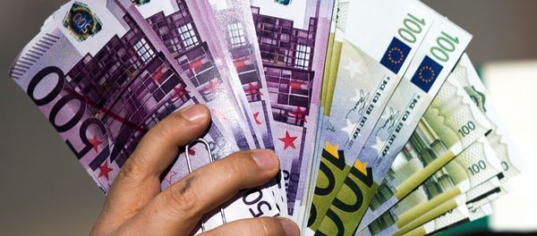 An activist shows fake banknotes during a demonstration outside the European Commission (EC) headquarters. An activist shows fake banknotes during a demonstration outside the European Commission (EC) headquarters. - Sputnik International