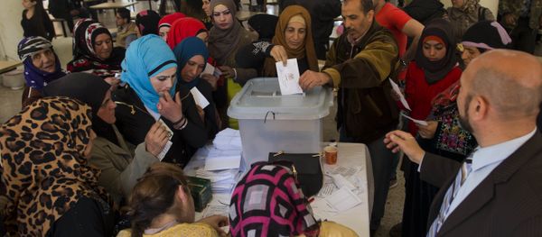 A Syrian woman casts her vote at a polling station during the Syrian parliamentary election in Damascus, Syria A Syrian woman casts her vote at a polling station during the Syrian parliamentary election in Damascus, Syria - Sputnik International
