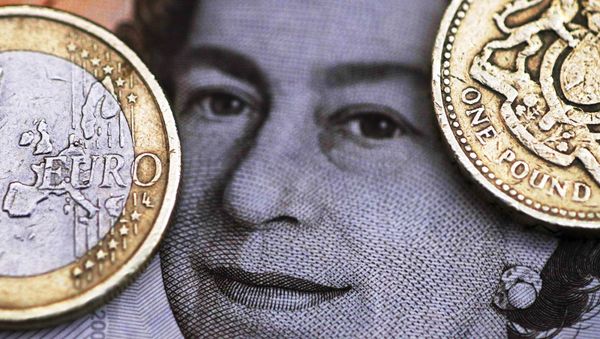 A two Euro coin is pictured next to a one Pound coin on top of a portrait of Britain's Queen Elizabeth in this file photo illustration shot March 16, 2016. A two Euro coin is pictured next to a one Pound coin on top of a portrait of Britain's Queen Elizabeth in this file photo illustration shot March 16, 2016. - Sputnik International