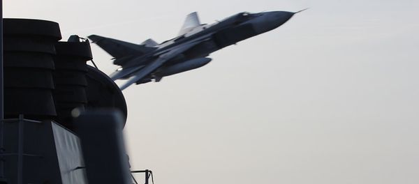 An undated US Navy picture shows what appears to be a Russian Sukhoi SU-24 attack aircraft making a very low pass close to the U.S. guided missile destroyer USS Donald Cook in the Baltic Sea. - Sputnik International