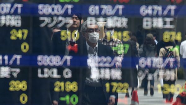 Pedestrians are reflected on an electronic stock quotation board at the window of a securities company in Tokyo on April 8, 2016 Pedestrians are reflected on an electronic stock quotation board at the window of a securities company in Tokyo on April 8, 2016 - Sputnik International